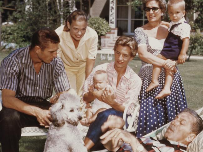 ONE TIME WEB USE ONLY - FEE APPLIES FOR REUSE -  Surrounded by his family, American movie producer, artist, and animator Walt Disney (1901 - 1966) lies in a hammock in the garden, with a poodle on his lap, 1950s. Among those pictured are his wife, Lillian (nee Bounds, 1899 - 1997) (left, in sunglasses), and their daughters Sharon (1936 - 1993) and Diane (1933 - 2013). (Photo by Gene Lester/Getty Images)