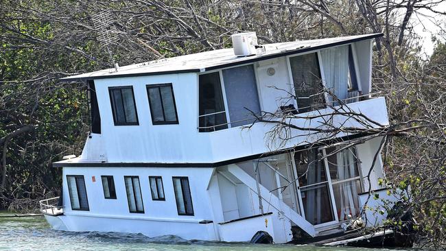 Windy and wild weather caused a houseboat to wash up at The Spit. Picture, John Gass