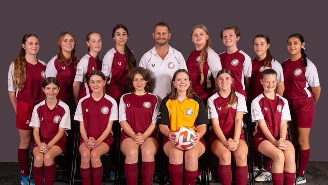 Celebrating their Team of the Week win are Coomera U15 girls players (from back left) Shannel Jovanovic, Piper Howard, Rilee Norris, Madalyn Gardiner, Matt Weir (Coach), Poppy Owen, Georgia Hindmarsh, Malia Schroeder, Valentina Jaques, Heidi Batchelor, Lara Warren, Bella Thomason, Ellysa Gooch, Ella Watson, Maddison Weir.