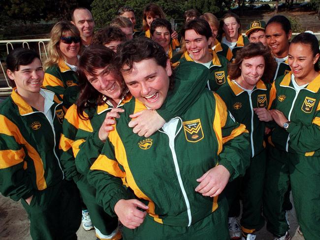 Captain Julie McGuffie grabs Katrina Fanning (cousin of Canberra's Laurie Daley), with other members of Australia's women's RL team. Rugby League / Women