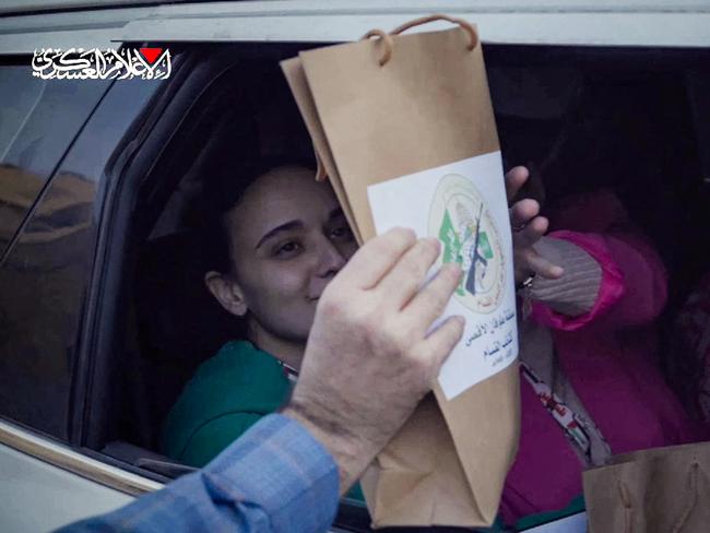 The Israeli hostages pose with documents bearing the logo of the Ezzedine al-Qassam Brigades, Hamas's armed wing, certifying the ceasefire and hostage-prisoner exchange deal. Picture: Hamas Media Office/AFP