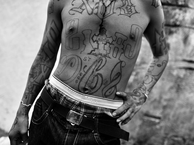 A M18 gang member shows off his tattoos in San Salvador in 2013. Picture: Jan Sochor/Rex/Getty.