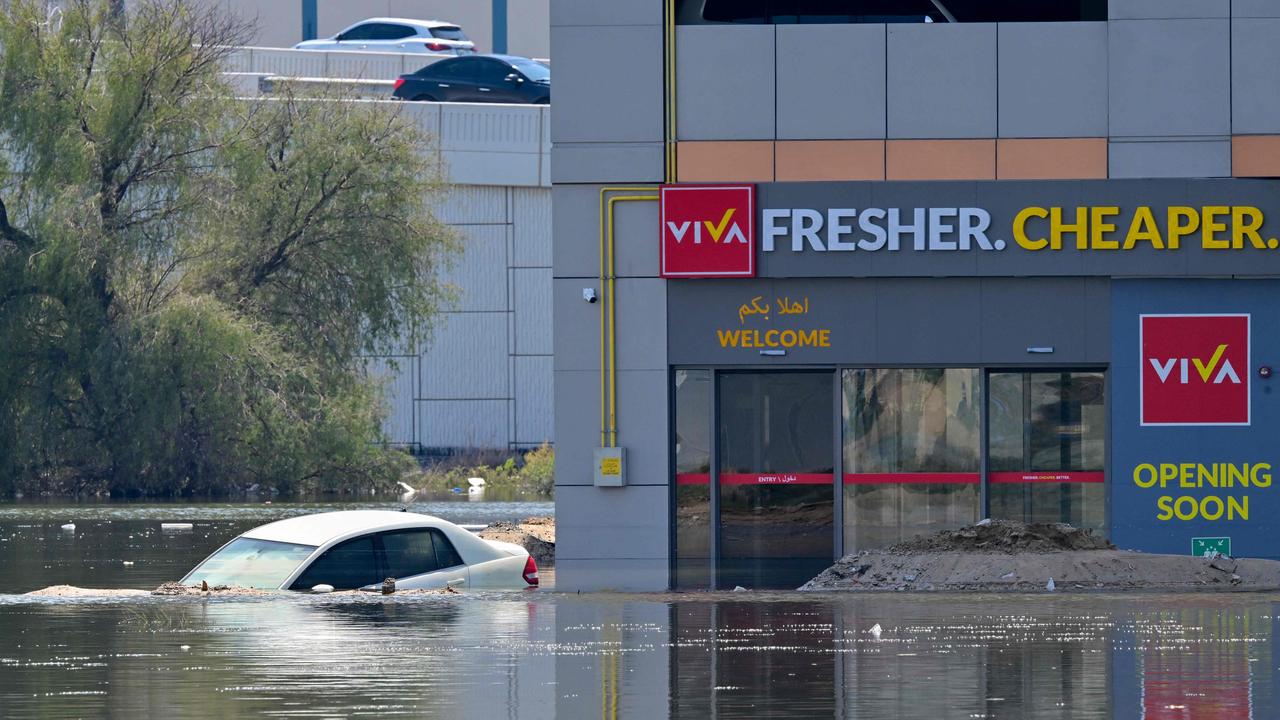 A car is stranded on a flooded street in Dubai following wild weather conditions. Picture: Giuseppe CACACE / AFP