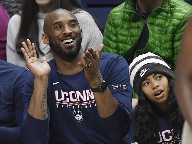 Kobe Bryant and his daughter Gianna watch the first half of an NCAA college basketball game between Connecticut and Houston in Storrs, Connecticut on March 2, 2019. Picture: AP