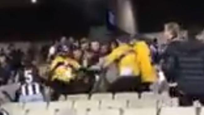 Collingwood fans wrestle with security guards at the MCG. Picture: Twitter