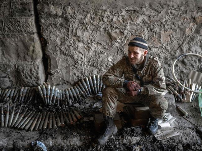 A Ukrainian soldier sits near ammunition in Bakhmut, eastern Ukraine, on November 9. Picture: Bulent Kilic / AFP)