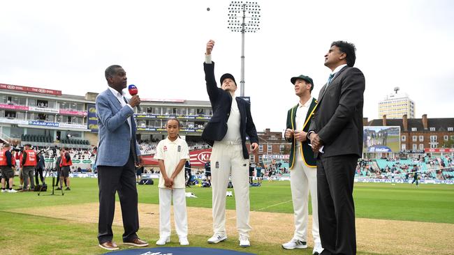 England’s Joe Root tosses the coin alongside Tim Paine. Picture: Getty Images