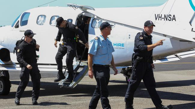 Members of the Special Operations Group arrive at Carnarvon airport to take Terence Darrell Kelly into custody in Carnarvon. Picture: Getty