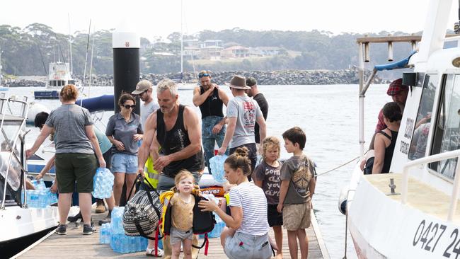 Ulladulla residents are using their own boats to take supplies and rescue people from towns that are isolated due to the fires. Picture: Darren Leigh Roberts