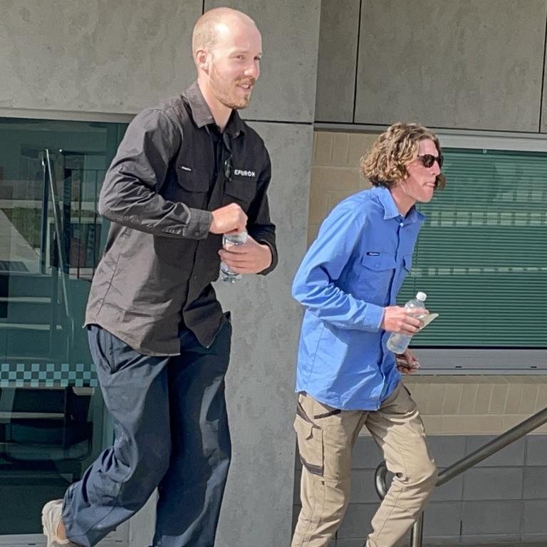 Two wind farm contractors caught up in the aftermath of a mass shooting at Bogie, west of Bowen, Qld on Thursday, August 4 are pictured at Bowen Police Station on the morning of Friday, August 5. They were two of five people questioned by police overnight.