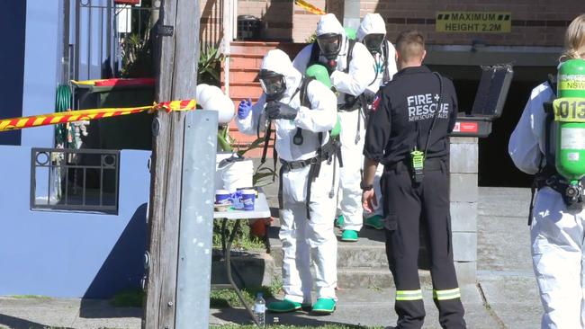 Emergency workers in protective clothing at the scene of a raid on an Arncliffe apartment where ‘nuclear collectables’, purchased from the US-based website Luciteria Science, were allegedly found. Picture: ONSCENE.