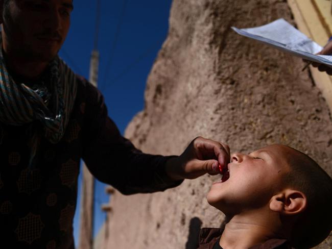 An Afghan health worker administers a polio vaccine to a child during a vaccination campaign in Herat province. Picture: Oshang Hashimi.