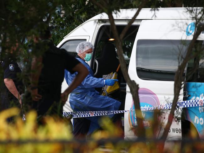 A police forensic officer inspects the van at Hambledon State School in Edmonton. Picture: Brendan Radke