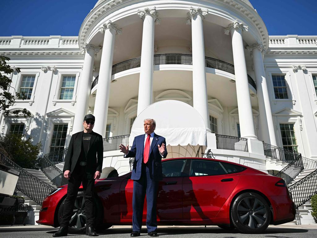 US President Donald Trump and Tesla CEO Elon Musk speak to the press as they stand next to a Tesla vehicle on the South Portico of the White House on March 11, 2025 in Washington, DC. (Photo by Mandel NGAN / AFP)