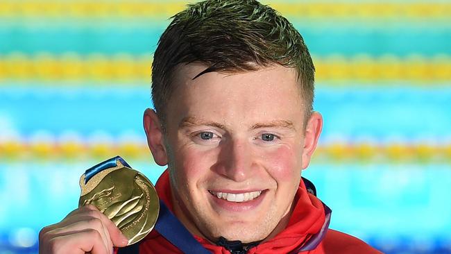 Gold medallist Britain's Adam Peaty poses with his medal after the final of the men's 50m breaststroke event during the swimming competition at the 2019 World Championships at Nambu University Municipal Aquatics Center in Gwangju, South Korea, on July 24, 2019. (Photo by Oli SCARFF / AFP)