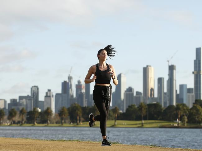 MELBOURNE, AUSTRALIA - AUGUST 04: People are seen exercising at Albert Park Lake on August 04, 2020 in Melbourne, Australia.  Retail stores across Melbourne will close to customers as further stage 4 lockdown restrictions are implemented in response to Victoria's ongoing COVID-19 outbreak. The new rules, which come into effect at 11:59 on Wednesday 5 August, will see the majority of retail businesses like clothing, furniture, electrical and department stores will be closed to the public for the duration of the stage 4 restrictions. Businesses will be able to operate click and collect services with social distancing and contactless payments. Supermarkets, grocery stores, bottle shops, pharmacies, petrol stations, banks, news agencies and post offices will remain open during the lockdown. Melbourne residents are subject to a curfew from 8pm to 5am, must stay within a 5km radius of their homes along with limits on hours of exercise, while all students will return to home learning and childcare centres will close. (Photo by Daniel Pockett/Getty Images)