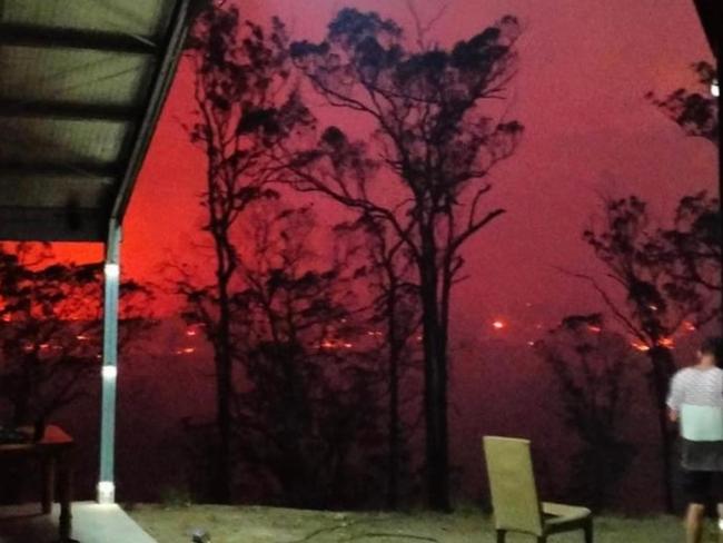 The out of control fire turned the sky red as it approached homes. Photo: Facebook/NSW Incidents