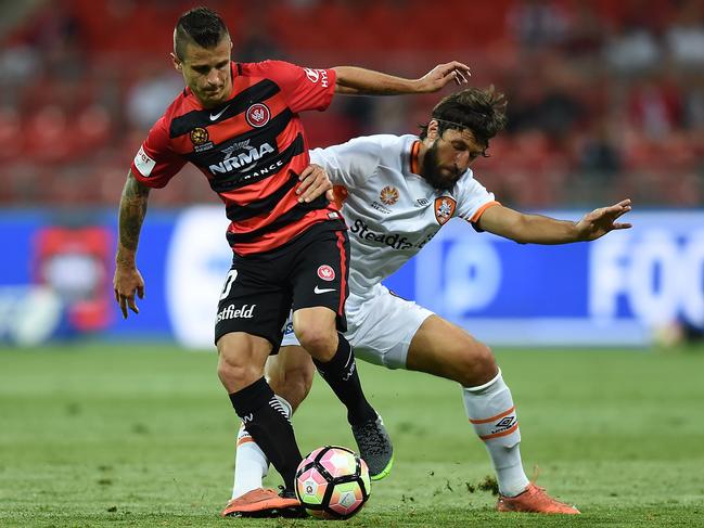 Nicolás Martínez of the Wanderers is tackled by Thomas Broich of the Roar during the round 8 A-League match between the Western Sydney Wanderers and Brisbane Roar at Spotless Stadium in Sydney, Friday, Nov. 25, 2016. (AAP Image/Dan Himbrechts) NO ARCHIVING, EDITORIAL USE ONLY