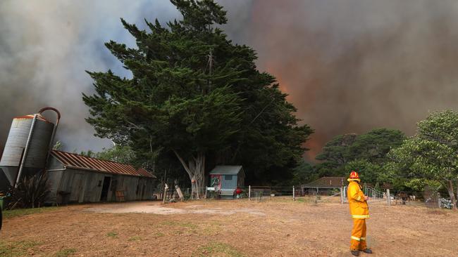 The bushfire looms over a property in Tynong North. Picture: Alex Coppel