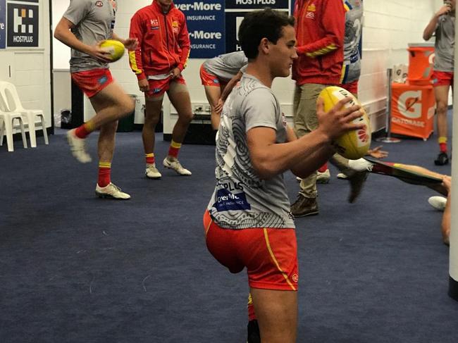 The Gold Coast Suns players in the dressing room ahead of their Round 16 game against North Melbourne at Etihad Stadium. Wil Powell (front) warming up. Picture: Supplied.