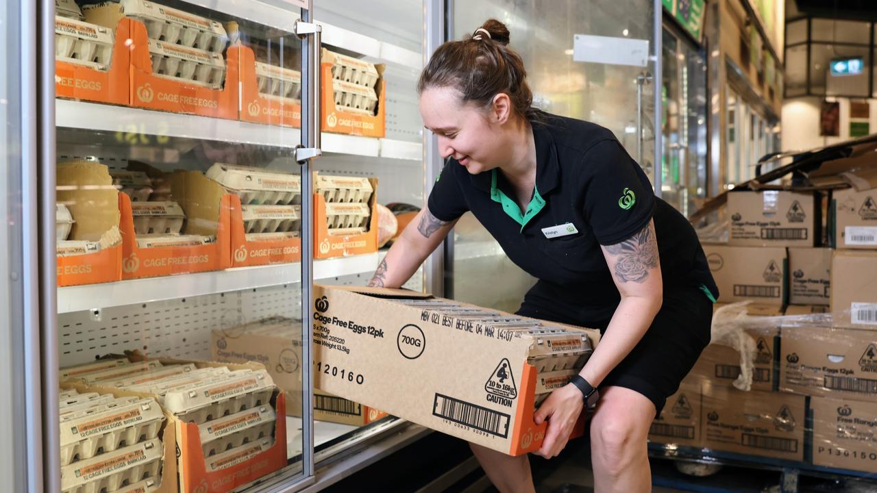 Woolworths Cairns Central store worker Kristyn Lee stocks cartons of eggs after taking deliveries of fresh food on Thursday morning. Picture: Brendan Radke