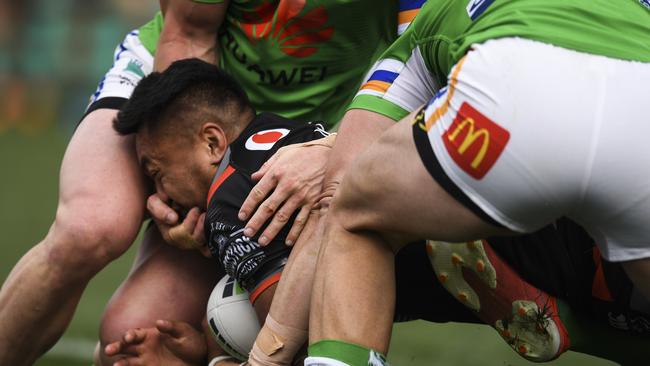 Hudson Young has his hand in the face of Adam Pompey. Photo: AAP Image/Lukas Coch