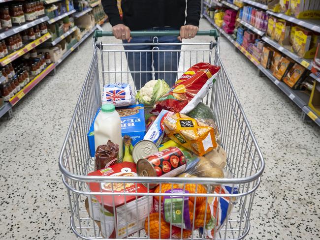 CARDIFF, WALES - MAY 22: A woman with a shopping trolley full of groceries in a supermarket aisle on May 22, 2022 in Cardiff, Wales. Last week, the UK Office for National Statistics reported an 6% average increase of food and drink prices year on year, but some staples, such as milk and pasta, had risen by more than 10%. (Photo by Matthew Horwood/Getty Images)