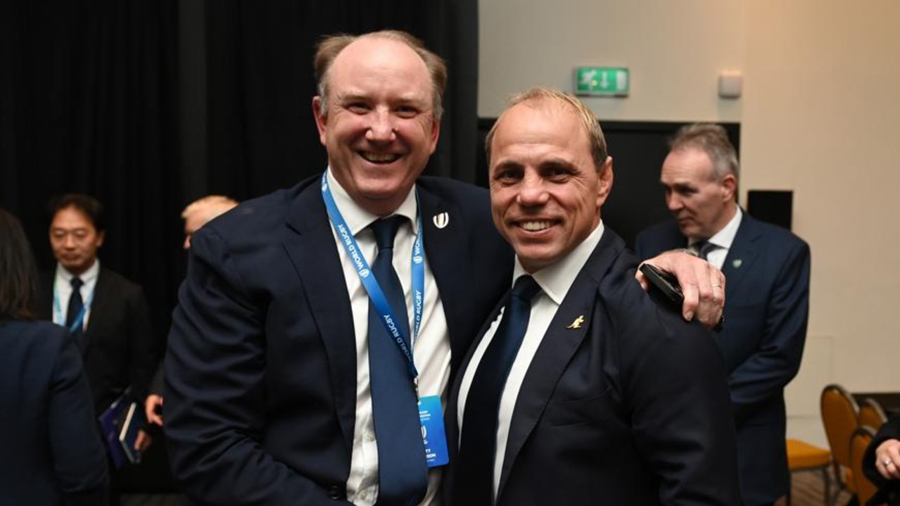 Newly elected World Rugby chair Brett Robinson (L) is congratulated by Rugby Australia CEO Phil Waugh