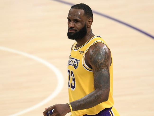 LOS ANGELES, CALIFORNIA - FEBRUARY 06: LeBron James #23 of the Los Angeles Lakers reacts after his three pointer in double overtime to lead the Lakers to a 135-129 win over the Detroit Pistonsat Staples Center on February 06, 2021 in Los Angeles, California.   Harry How/Getty Images/AFP NOTE TO USER: User expressly acknowledges and agrees that, by downloading and/or using this Photograph, user is consenting to the terms and conditions of the Getty Images License Agreement. Mandatory Copyright Notice: Copyright 2021 NBAE. == FOR NEWSPAPERS, INTERNET, TELCOS & TELEVISION USE ONLY ==