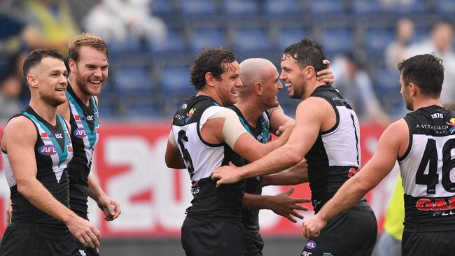 Power players congratulate Sam Powell-Pepper after a goal against Gold Coast in Shanghai. Picture: David Mariuz/AAP