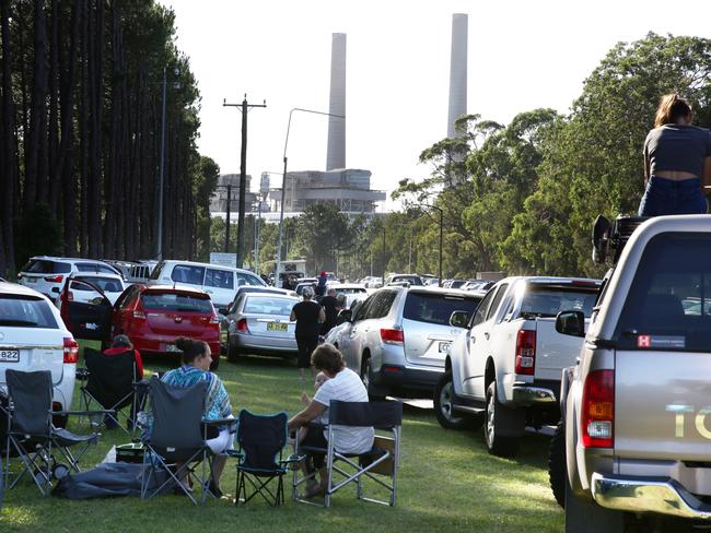 A big crowd turned up to watch the Munmorah Power Station’s two chimneys demolished this morning. Picture: Mark Scott