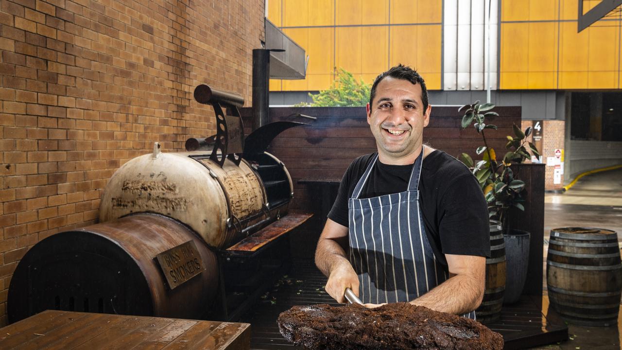 Proof BBQ and Booze pitmaster Deniz Altintas shows off some the restaurant smoked meat. The Toowoomba venue’s owner Ryan Lane is looking forward to the lifting of vaccine mandates next week. Picture: Kevin Farmer