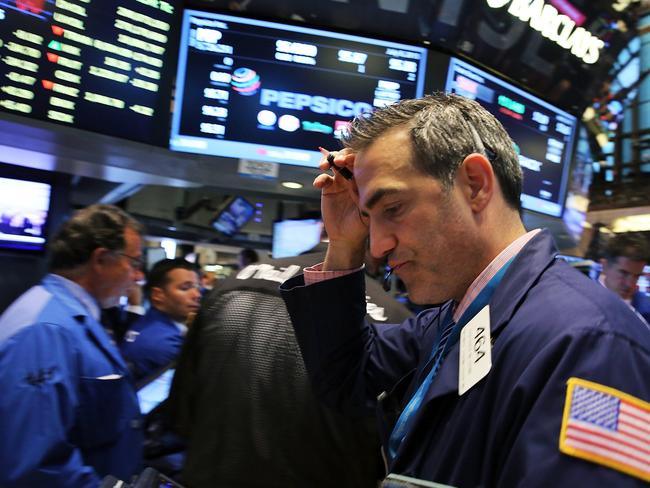 NEW YORK, NY - JULY 08: Traders work on the floor of the New York Stock Exchange (NYSE) at the close of the day after trading was paused for nearly four hours due to a "technical glitch" on July 8, 2015 in New York City. The unprecedented shutdown was said was caused by a major technical glitch and not the result of a cyberattack. Spencer Platt/Getty Images/AFP == FOR NEWSPAPERS, INTERNET, TELCOS & TELEVISION USE ONLY ==