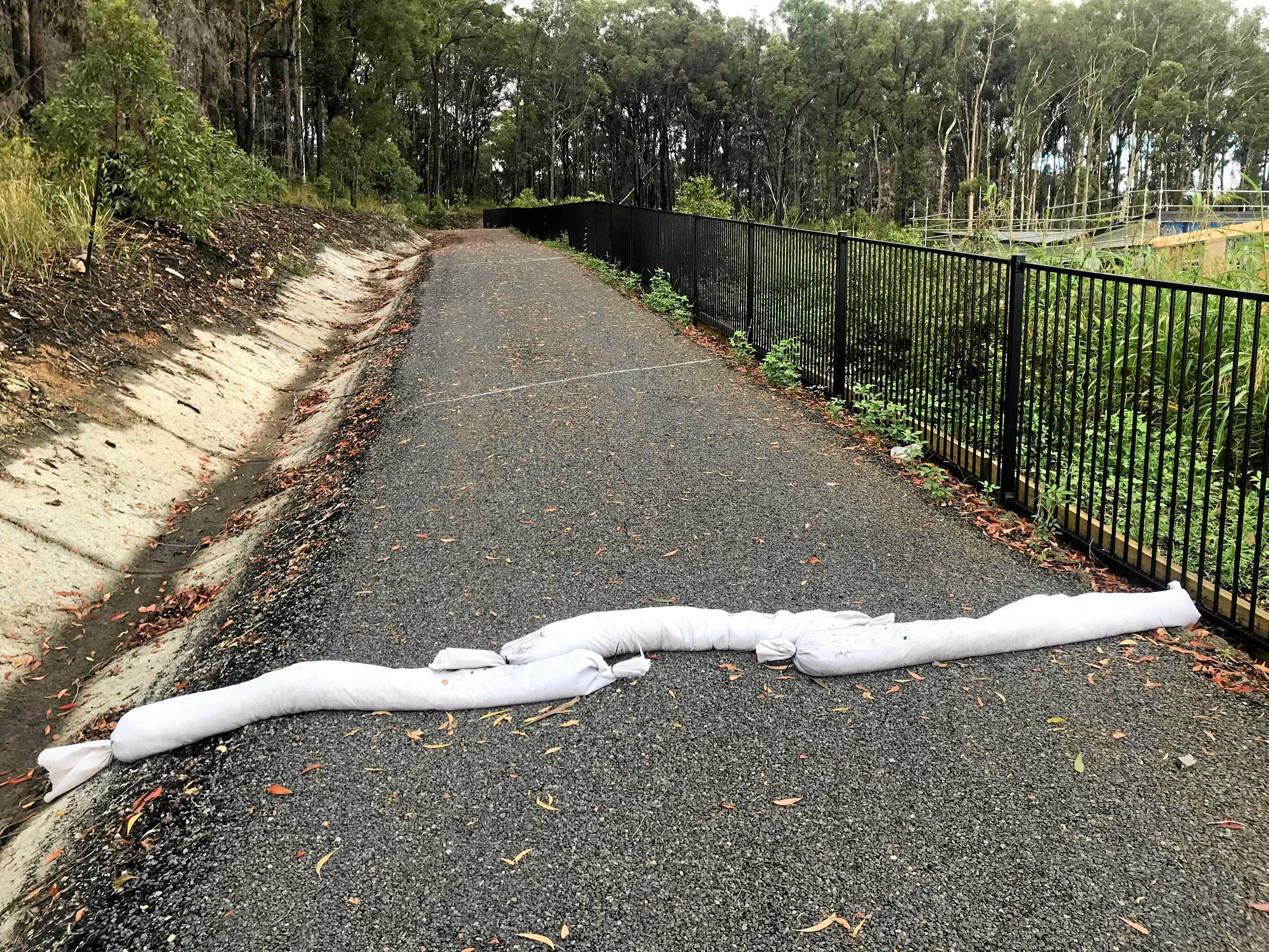 DELUGE: The downpours in mid-November sent muddy water sprawling across this street in Parklakes 2. Picture: Contributed