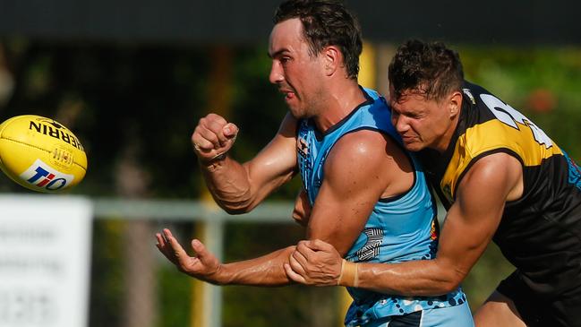 The Buffaloes’ North Adelaide recruit Patrick Boles gets a handball away despite the attention of Tiger Jonathan Peris. Picture: GLENN CAMPBELL