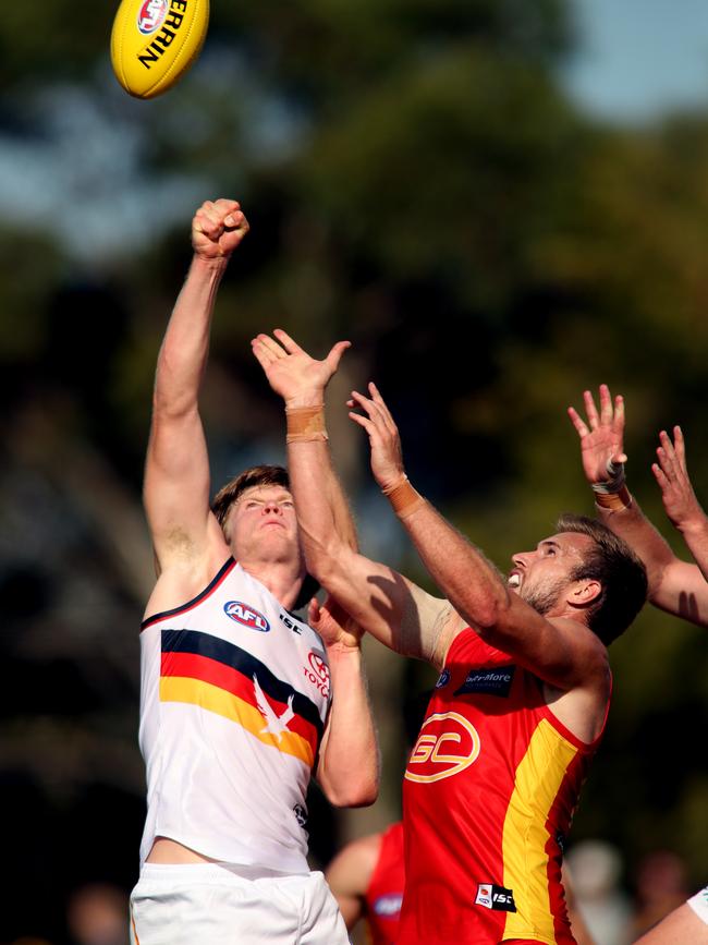 Crow Fischer McAsey spoils a marking attempt from Gold Coast opponent Sam Day in Friday’s pre-season clash. Picture: Kelly Barnes (AAP)