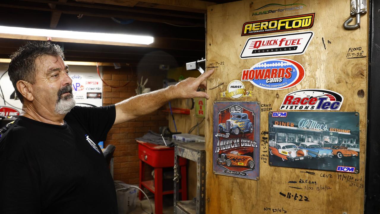 Steve Arnold points to the water level in his garage from the 2022 flood as he moves items to higher ground at his Chipping Norton home. Picture: Jonathan Ng