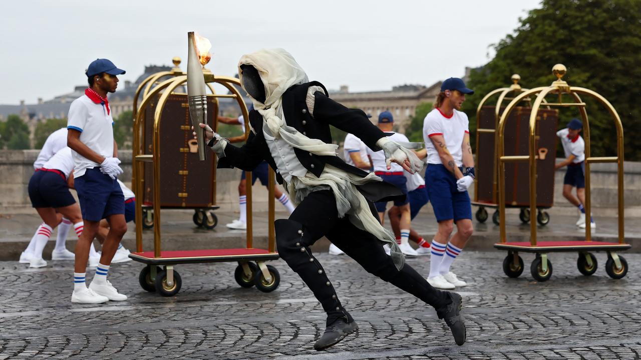 The masked individual runs through a performance. (Photo by Maddie Meyer/Getty Images)