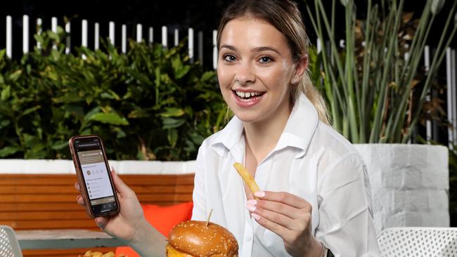 Jessica Turner, 20, at Bella Vista Hotel using the OrderUp app that allows people to order and pay for food without talking to anyone. Picture: Jonathan Ng