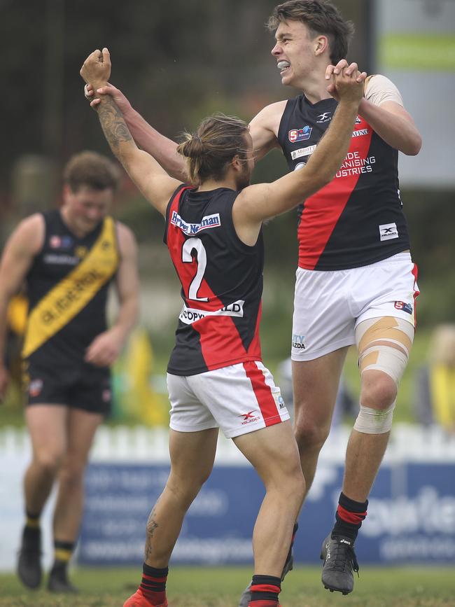 Riley Thilthorpe celebrates a goal with West Adelaide teammate Kenny Karpany against premier Glenelg last season. Picture: Dean Martin/AAP.