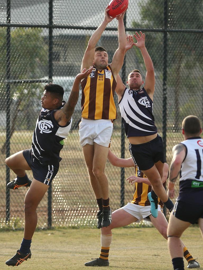 RDFL: Woodend-Hesket’s Rory Alexander rises above his Melton Cental opponents. Picture: Hamish Blair