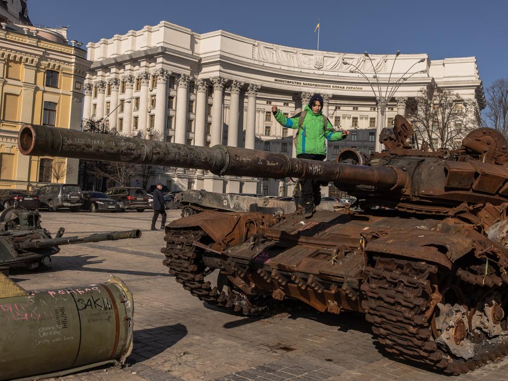 A boy climbs a destroyed Russian tank on display in Mykhailivskyi Square. Picture: Getty