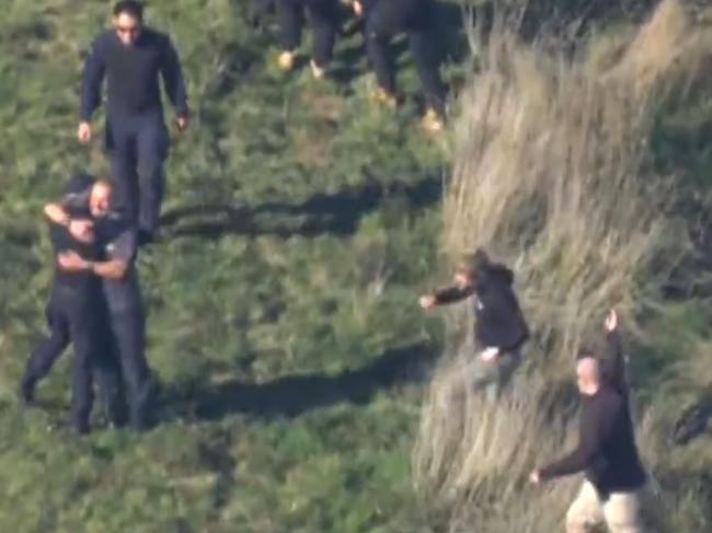 Police officers celebrate after finding a possible clue. Picture: 9News