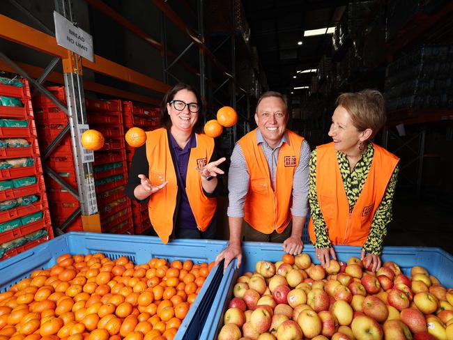 Foodbank Qld Exec officer Jess Watkinson Premier Steven Miles and Dir Farmer at food bank in Morningside  .Pic Annette Dew