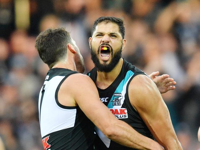 Patrick Ryder of the Power (right) celebrates with teammate Travis Boak after kicking a goal during the Round 8 AFL match between the Port Adelaide Power and the Adelaide Crows at Adelaide Oval in Adelaide, Saturday, May 12, 2018. (AAP Image/David Mariuz) NO ARCHIVING, EDITORIAL USE ONLY