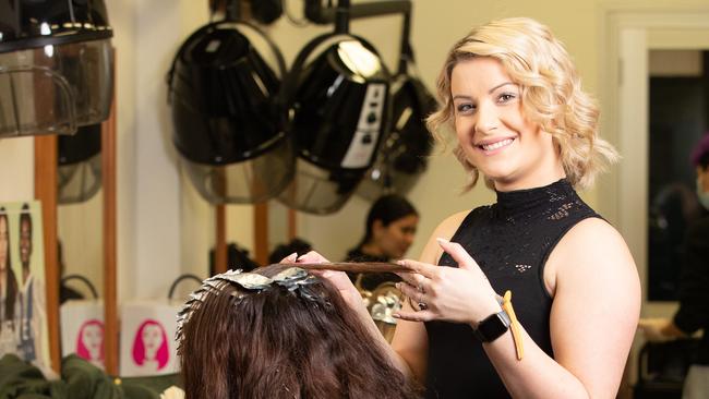 Apprentice hairdresser Abril Gonzalez provides an affordable hair appointment at Granville TAFE. Picture: Ryan Osland