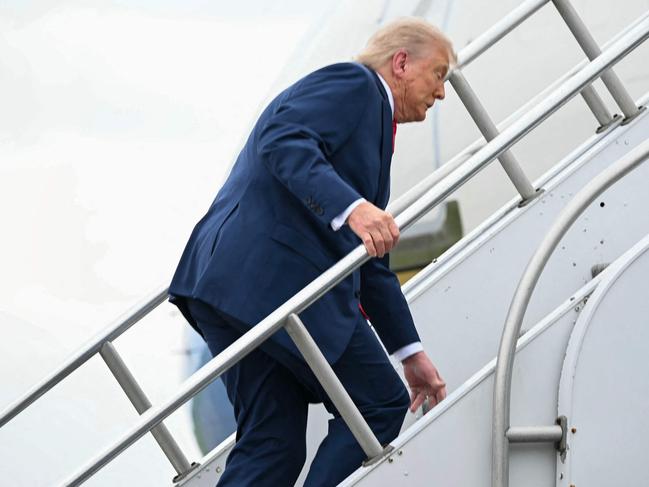 US President Donald Trump trips while boarding Air Force One prior to departure from Morristown Municipal Airport in Morristown, New Jersey, en route to Camp David. Picture: AFP