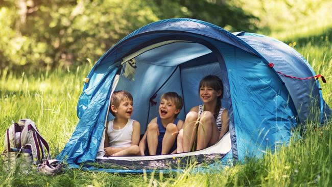 SHFG. Little girl and brothers are camping in a tent in a sunny forest. Picture: iStock