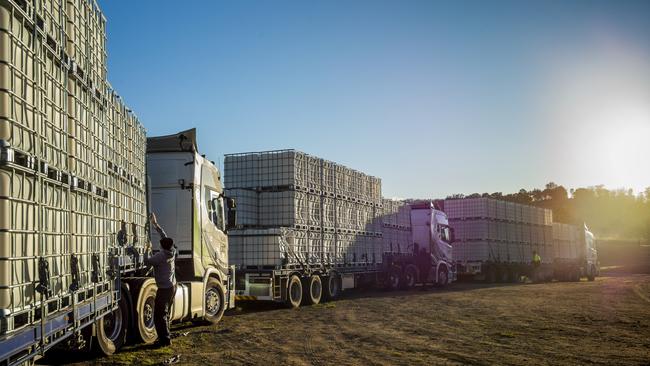 Semi-trailers loaded with water tanks arrive at Cobargo Showgrounds in NSW last month. Picture: Sean Davey