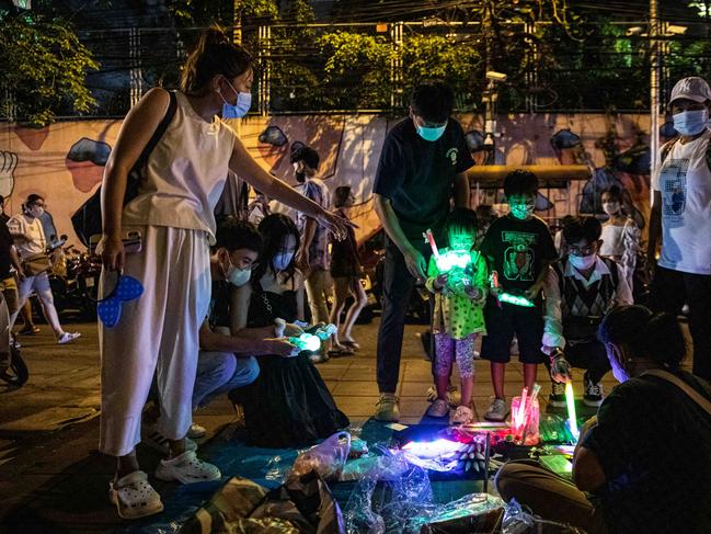 People buy light up glasses before watching the New Year’s Eve fireworks in Bangkok. Picture: Getty Images